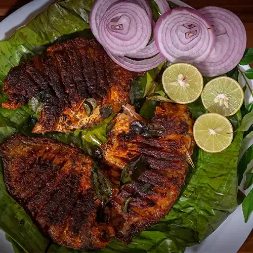 What to see do in Kumarakom? 13 Karimeen Pollichathu Kumarakom traditional Kerala food signature dish banana leaf