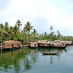 tourist attractions in Kumarakom — traditional kettuvallam houseboat backwater canal Kerala