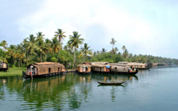 tourist attractions in Kumarakom — traditional kettuvallam houseboat backwater canal Kerala
