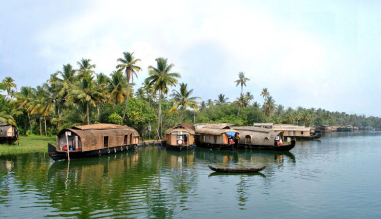 tourist attractions in Kumarakom — traditional kettuvallam houseboat backwater canal Kerala
